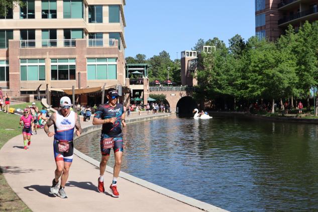People running along The Woodlands Waterway during IRONMAN Texas in The Woodlands, Texas