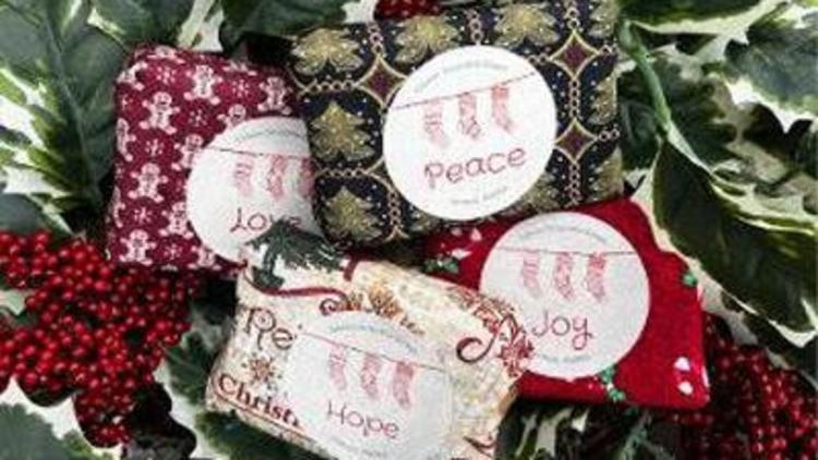 soap bars containing glacial silt wrapped in colorful christmas fabric