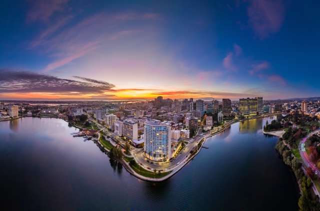 Aerial shot of Lake Merritt with Downtown Oakland in the background during a sunset