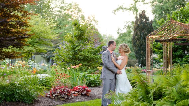 A couple embrace amidst the Avon Gardens (Nate Crouch Photography).