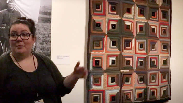 Women showing a quilt at the Eiteljorg Museum