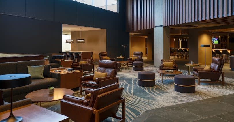 A long conference table surrounded by leather swivel chairs.