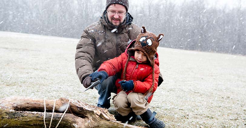 A man and his son play in the snow at Busse Woods in Chicago NW