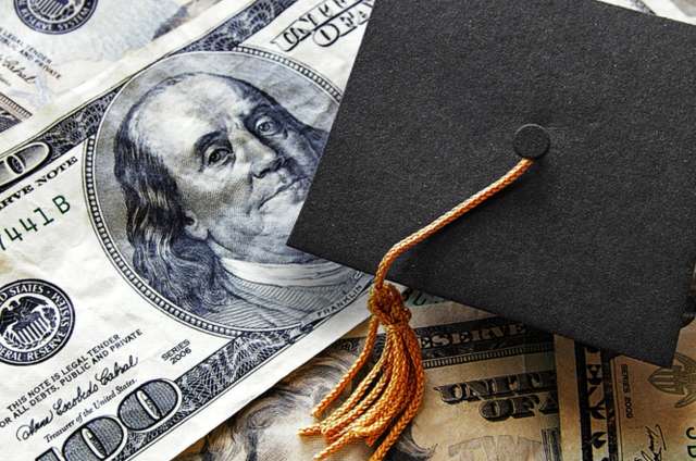 Graduation hat on money.