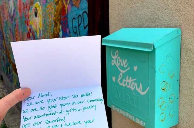 Letter on card with teal blue mail box behind