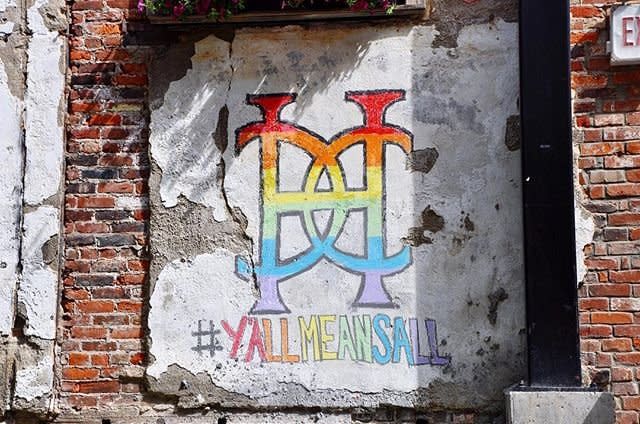 A rainbow colored chalk sign at Hotel Covington that reads #yallmeansall