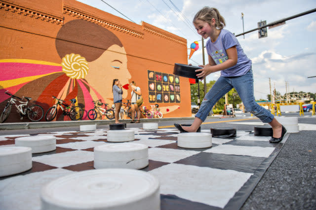 Little girl playing giant checkers