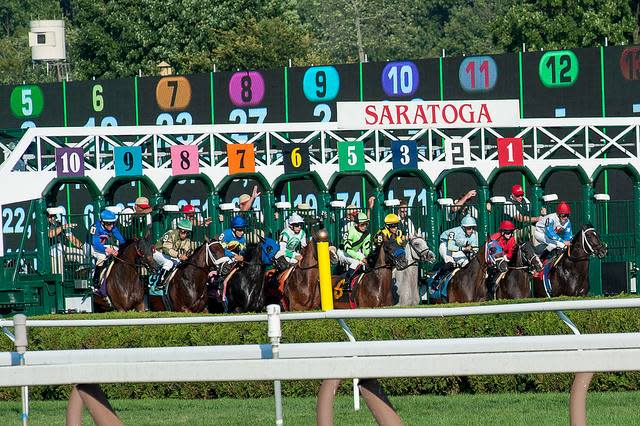 Horses leaving the starting gate as a race begins