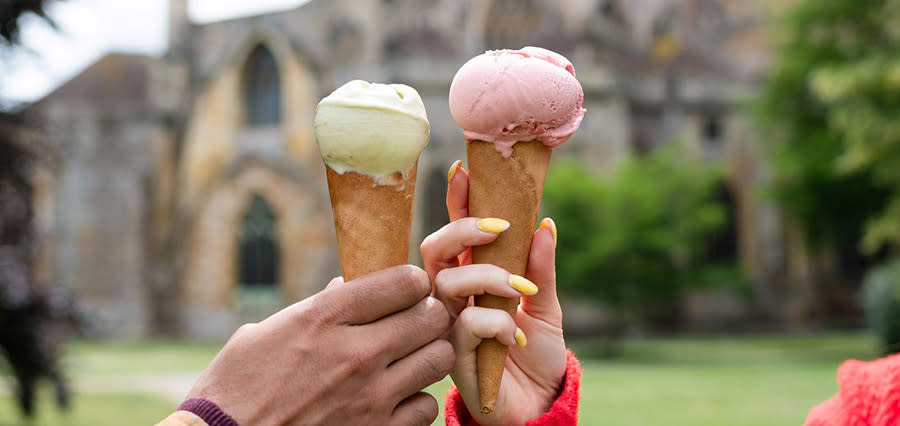Two hands holding ice creams 