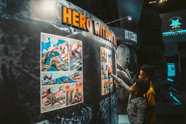 kids look at "hero within you" wall at Medal of Honor Heritage Center