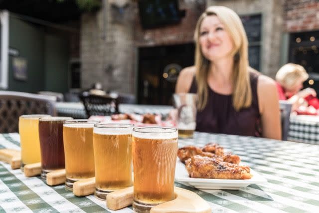 A woman with a flight of beers from Shale Creek Brewing in Franklin Johnson County Festival Country