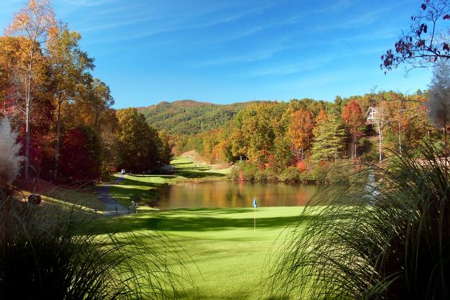 Fall color backdrop at Rumbling Bald Golf Course