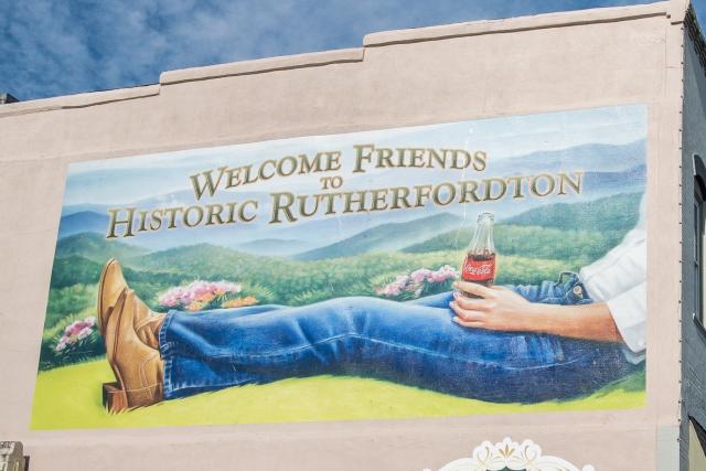 A Welcome to Rutherfordton mural features nostalgia with a Classic Coca-Cola bottle.