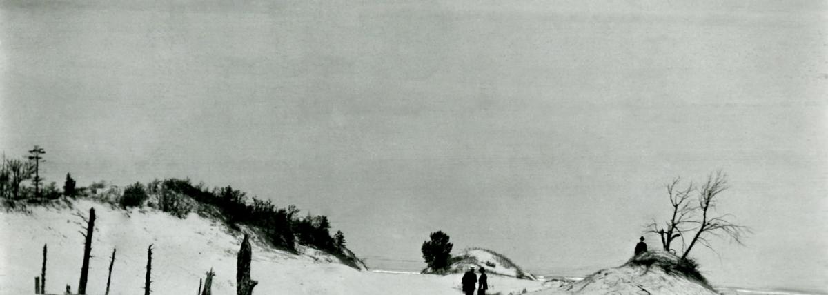 Old photograph of people walking in the dunes