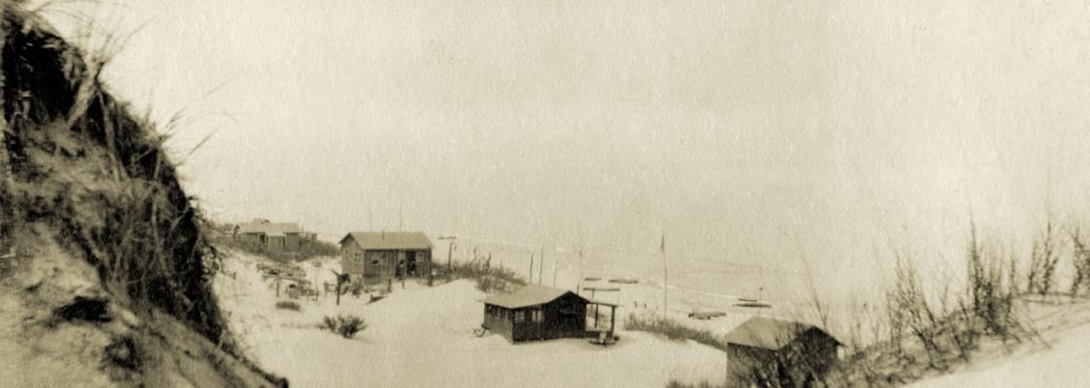 Old photograph of small houses overlooking the lake