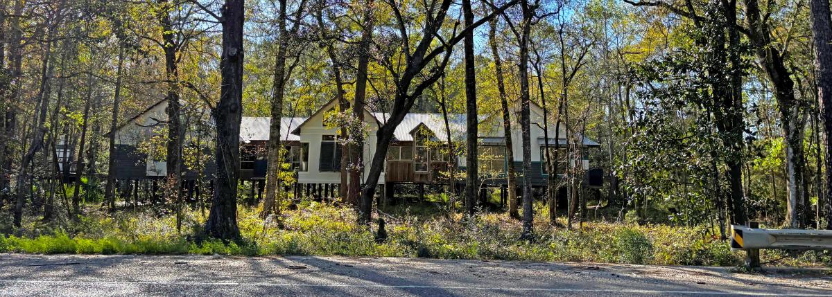 The Visit The Northshore Visitor Center sits among tall trees and native vegetation along U.S. Highway 59 in Mandeville, Louisiana.