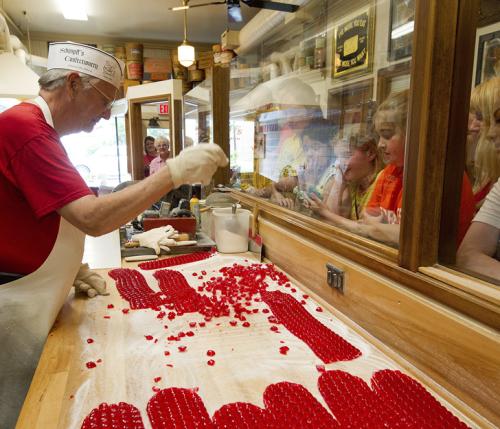 Candy maker working on red candy at Schimpff's