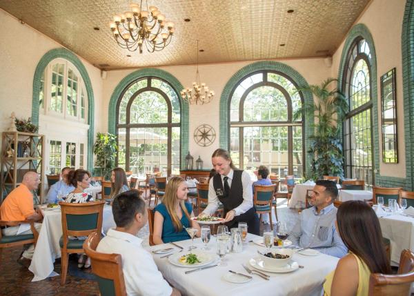 a Waitress serves people seated at a table at 1741 on the Terrace