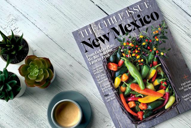 An image of the September/October issue of New Mexico Magazine with a cup of coffee and three succulents