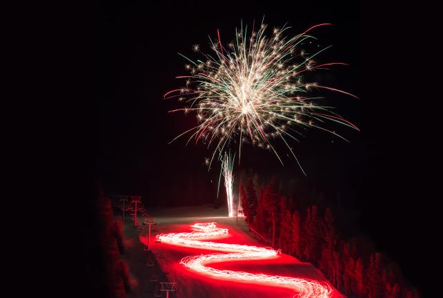 Red River’s Torchlight Parade floods the town with light.