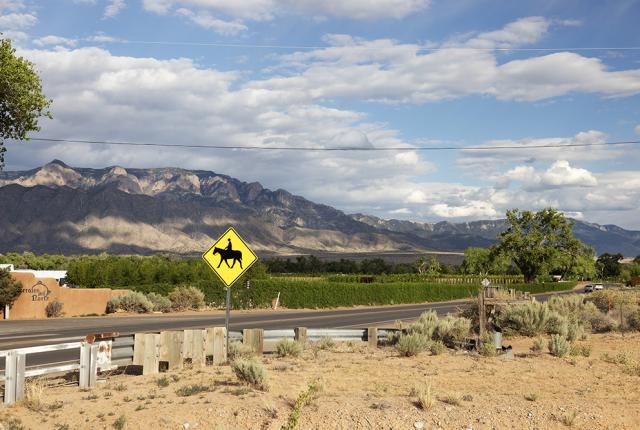 Corrales is known for its verdant fields and vineyards, focusing on vegetable and grape cultivation, supported by local markets and places like Milagro Vineyards & Winery.