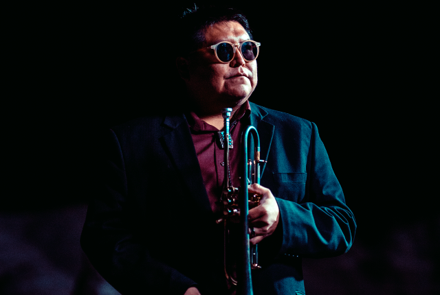 Delbert Anderson plays trumpet onstage.