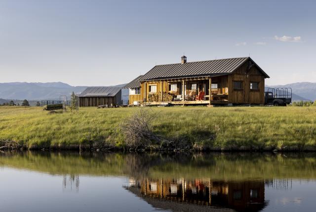 Trout Stalker Ranch reflects in the water in Chama