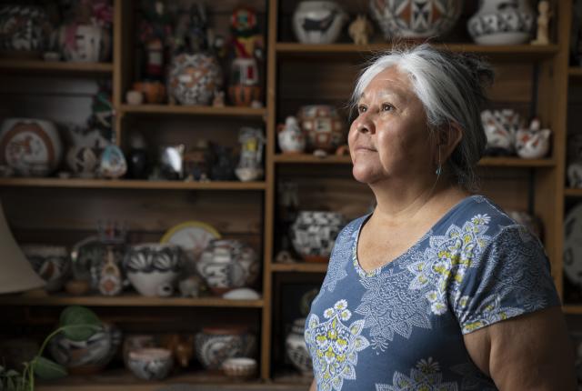 Acoma potter Claudia Mitchell and a collection of her work