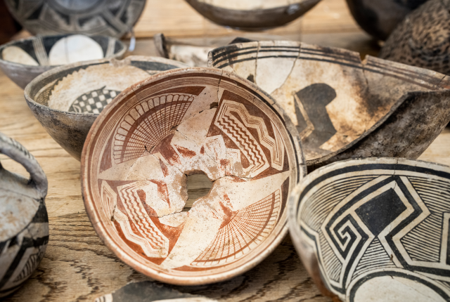 Pottery by Mimbres people with painted red and black designs.