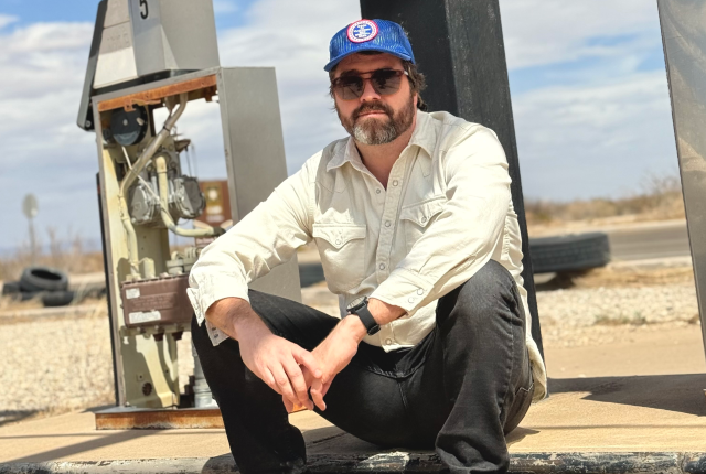 Joshua Wheeler sits on an abandoned gas pump along NM54 near his family's former ranch.