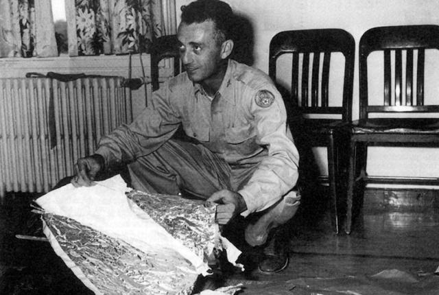 Major Jesse Marcel holds debris found near Roswell.
