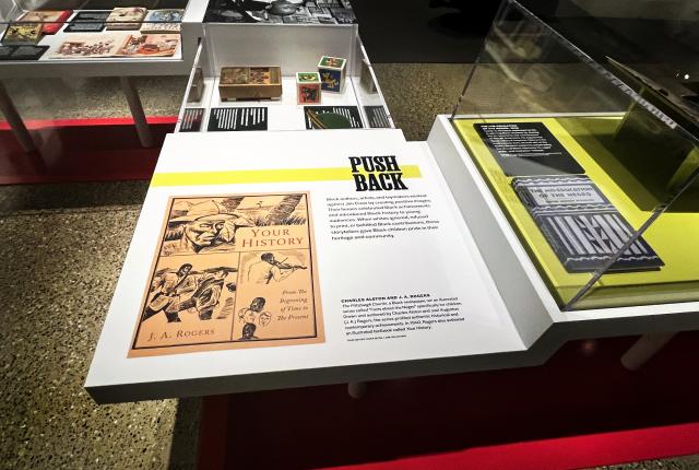 Exhibition display cases with historical publications and a panel titled "Push Back."