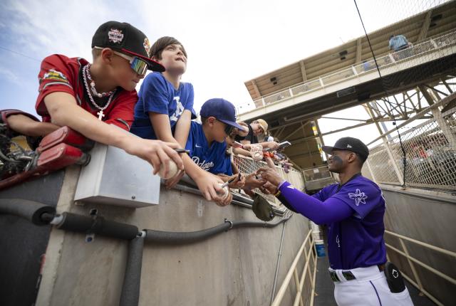 Julio Carreras signs autographs for young fans before the game.