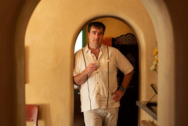 Lambert’s owner Nathaniel Troy Jr. stands in one of the cozy adobe’s many nooks.