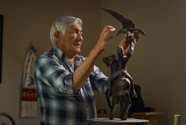 Michael Naranjo in 2022 with his sculpture "Earth, Fire and Wind."