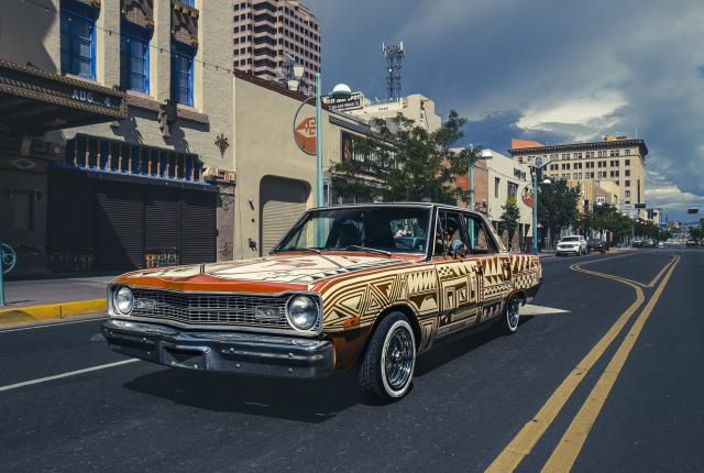 Sovereign Santa Fe at La Fonda on the Plaza's Lumpkins Ballroom features Jessie Littlebird's painted 1973 Dodge Dart.