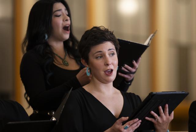 Two Santa Fe Desert Chorale vocalists performing during a holiday concert.