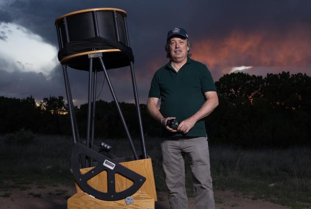 Astronomer Peter Lipscomb with his 20-inch Newtonian reflector telescope.