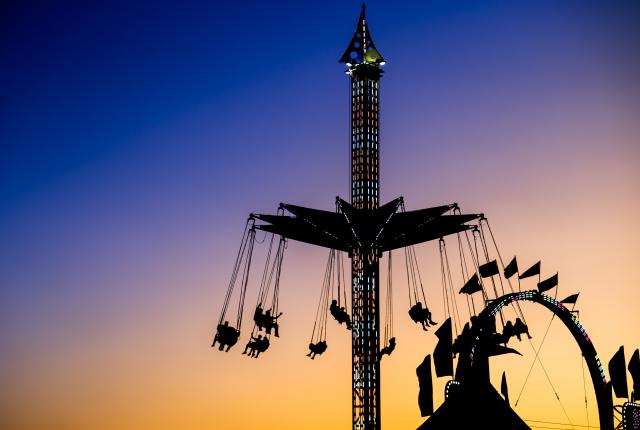 New Mexico State Fair rides in silhouette at sunset