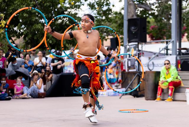 A hoop dancer performs at Indian Market.