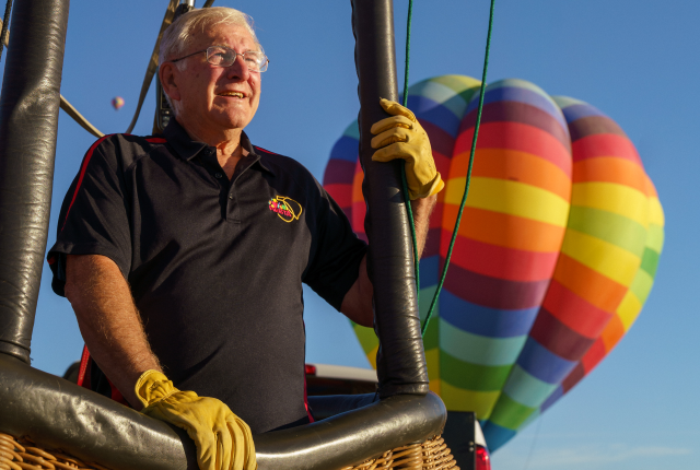 Ray Bair in hot air balloon basket.