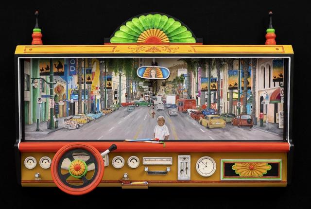 Colorful artwork resembling a car dashboard with a vibrant city street scene through the windshield. Includes a steering wheel, gauges, and a rearview mirror.
