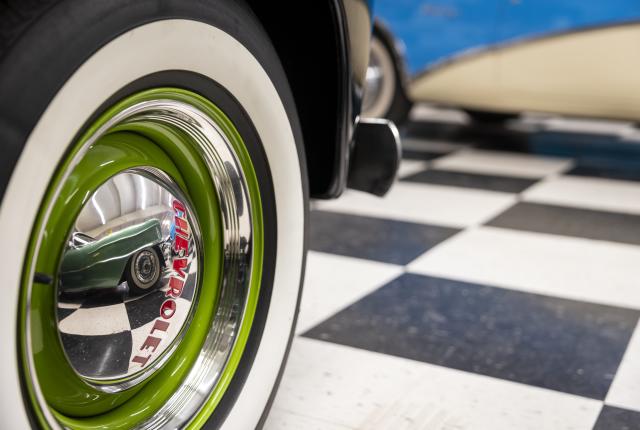 Vintage green-rimmed car tire on display at a Route 66 museum in New Mexico.