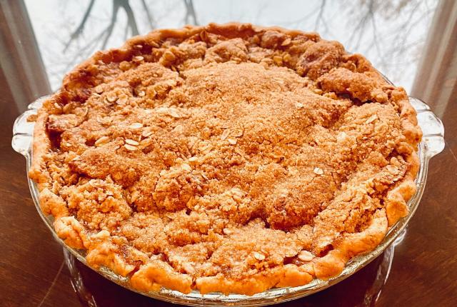 Homemade sweet potato casserole on glass table.