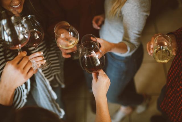 Group of friends cheering with wine glasses.