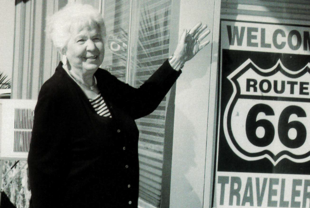 Black and white photograph of Bettie Ditto outside Best Western Pow Wow Inn.