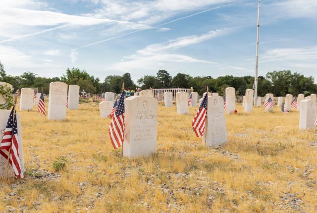 American flags mark the graves of veterans, whose collective service begins with the Civil War and runs through the Korean War at Fairview Memorial Park