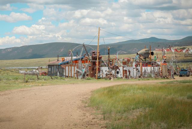 Whatville's colorful found-object sculptures and reworked structures spread across a grassy field near Angel Fire.