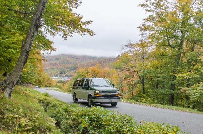 Mt. Washington Auto Road (Coach Tour in Fall - Van Driving Up Road with Fall Leaves and Mountains in Background)