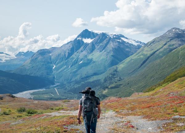 a hiker on a trail in the mountains